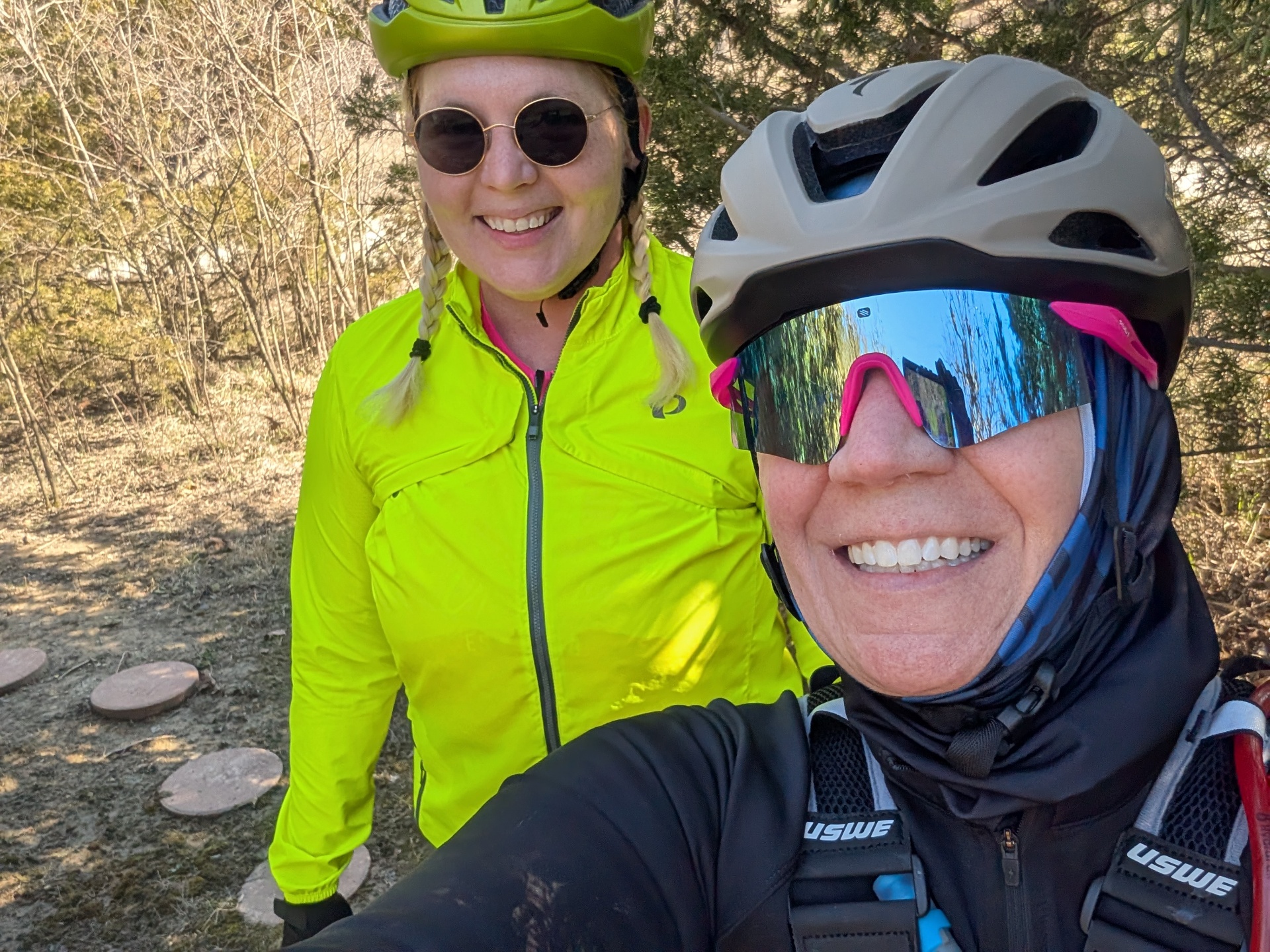 Two women smiling together on a gravel ride